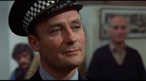 Sergeant Howie (Edward Woodward) looks on the islanders with smug condescension in Robin Hardy's The Wicker Man (1973)