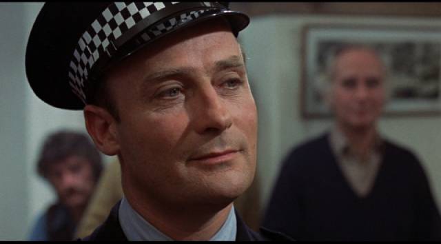 Sergeant Howie (Edward Woodward) looks on the islanders with smug condescension in Robin Hardy's The Wicker Man (1973)