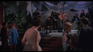 Tara (Holly Near) is drawn to singer Bogart Peter Stuyvesant (Jordan Christopher) at her coming out party in Robert Thom's Cult of the Damned (1969)