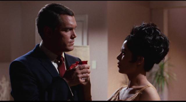 Agent Justin Power (Jeffrey Hunter) doesn't know if he can trust Kitty (France Nuyen) in Franklin Adreon's Dimension 5 (1966)