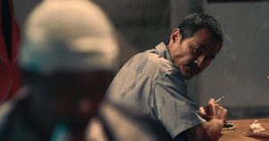 Lao Shi (Gang Chen) pursues the man he injured in Johnny Ma's Old Stone (2016)