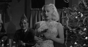 Mamie Van Doren entertains a Christmas party in Edward L. Cahn's Guns, Girls and Gangsters (1958)