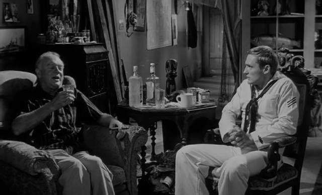 Captain Samuel Murdock (Gavin Muir) recounts the fantastical history of Mora (Linda Lawson) to Johnny (Dennis Hopper) in Curtis Harrington's Night Tide (1961)