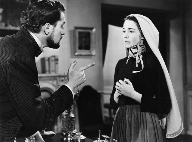Prosecutor Vincent Price tries to get Bernadette (Jennifer Jones) to recant in Henry King's The Song of Bernadette (1943)