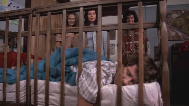 Mrs. Wadsworth (Ruth Roman) introduces social worker Ann Gentry (Anjanette Comer) to Baby (David Manzy) in Ted Post's The Baby (1973)