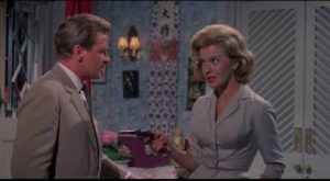 Don Benton (Richard Basehart) isn't sure which side Lola Sanchez (Lisa Gastoni) is on in Michael Carreras' Visa to Canton (1960)