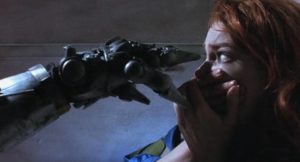 Artist Jill (Stacey Travis) inadvertently awakens a killer robot in Richard Stanley's Hardware (1990)