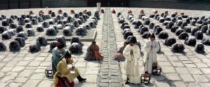 Acolytes and guests gather in the temple courtyard for the Abbot (Kim Chang-gean)'s announcement of a successor in King Hu's Raining in the Mountain (1979)