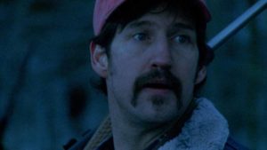 Otis (John Speredakos), a hunter with anger management issues, threatens a vacationing family in Larry Fessenden's Wendigo (2001)