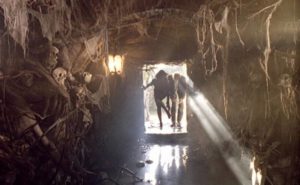 Cemetery caretaker Dellamorte (Rupert Everett) gives a tour of the ossuary in Michele Soavi's Dellamorte Dellamore (1994)