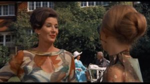 A prickly moment between Ellie's stepmother (Lois Maxwell) and Greta (Britt Ekland) at a garden party in Sidney Gilliat's Endless Night (1972)