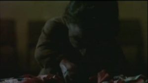 Ratman (Nelson de la Rosa) helps himself to a midnight snack in Giuliano Carnimeo's Ratman (1988)