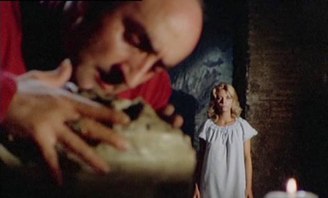 Family retainer Isidro (Giuseppe Carbone) plays with the contents of the crypt in Mario Bianchi's Satan's Baby Doll (1982)