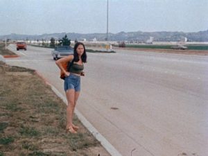 A runaway is unaware that danger is approaching in Irvin Berwick's Hitch Hike to Hell (1977)