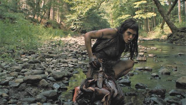 The woman cleans her wounds in a stream in Lucky McKee's The Woman (2011)