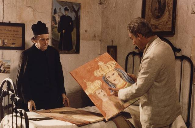 The exiled priest (François Simon) shows Carlo Levi (Gian Maria Volontè) his own paintings in Francesco Rosi's Christ Stopped at Eboli (1979)