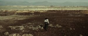 Candy (Daniel Tadesse) scours the wasteland for pre-war artefacts in Miguel Llanso's Crumbs (2015)