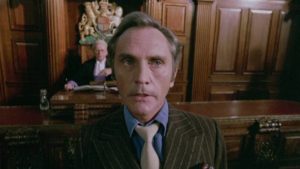 Willie Parker (Terence Stamp) testifies against his gang at the start of Stephen Frears' The Hit (1984)
