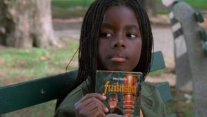 Pearline (Camille Winbush) talks books with Ghost Dog (Forest Whitaker) in the park in Jim Jarmusch's Ghost Dog: The Way of the Samurai (1999)