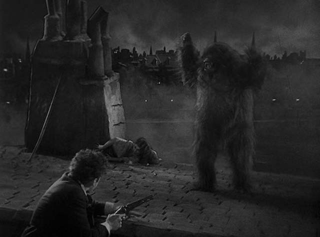 Pierre Dupin (Leon Ames) rescues Camille (Sidney Fox) from Erik on a Paris rooftop in Robert Florey's Murders in the Rue Morgue (1932)