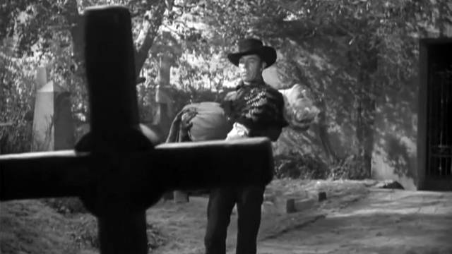Gunslinger Drake Robey (Michael Pate) is at home in the graveyard in Edward Dein's Curse of the Undead (1959)