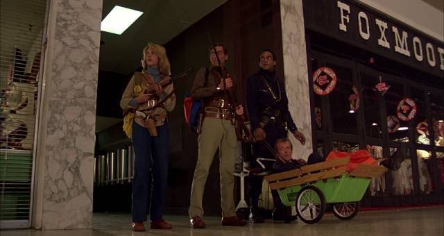 Fran (Gaylen Ross), Stephen (David Emgee), Peter (Ken Foree) and Roger (Scott H. Reiniger) claim the consumer paradise for themselves in George A. Romero's Dawn of the Dead (1978)