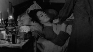 Mouchette (Nadine Nortier) presides alone over her mother's painful death in Robert Bresson's Mouchette (1967)