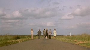 The group of friends wander endlessly in search of a good meal in Luis Bunuel's The Discreet Charm of the Bourgeoisie (1972)