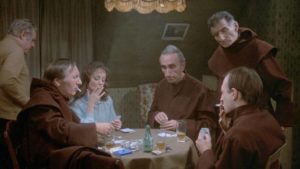 After prayer, the monks enjoy a game of poker in the nurse's room in Luis Bunuel's The Phantom of Liberty (1974)