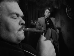 The Fat Man (Bruno Ve Sota) is completely disinterested in the Gamin (Adrienne Barrett) in John Parker's Dementia (1953)