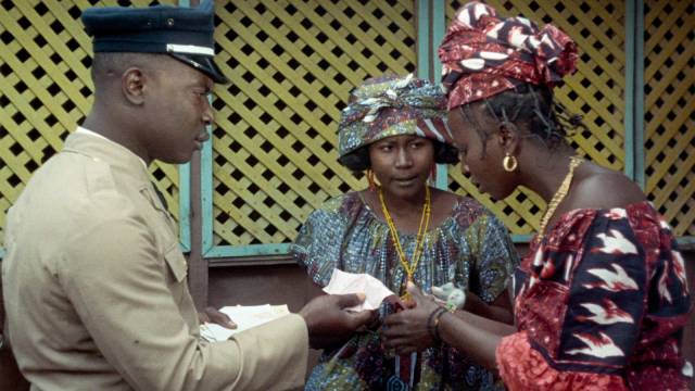 The postman delivers a money order to Ibrahim's wives in Ousmane Sembene's Mandabi (1968)