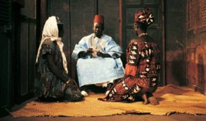 Wives Mety (Ynousse N'Diaye) and Aram (Isseu Niang) present the money order to Ibrahim (Makhouredia Gueye) in Ousmane Sembene's Mandabi (1968)