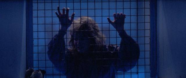 Dr. Joan Gilmore (Belinda Montgomery) is pursued by a mad killer in Simon Nuchtern's Silent Madness (1984)