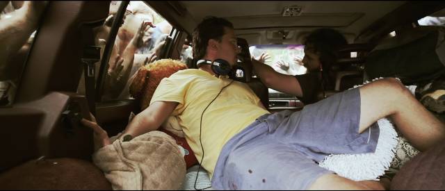 Ben (Jeremy Gardner) and Mickey (Adam Cronheim) are trapped in their station wagon by a crowd of zombies in Jeremy Gardner's The Battery (2012)