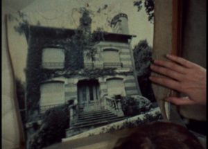 Julie (Dominique Labourier) has an old photograph of the house in a trunk in Celine and Julie Go Boating (1974) ...