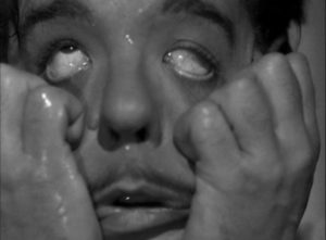 Artist Dave Stuart (Chaney) accidentally puts acid in his eyes in Reginald Le Borg's Dead Man's Eyes (1944)