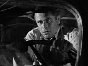 Unemployed engineer Mike Lambert (Glenn Ford) loses his brakes driving down a mountain in Richard Wallace's Framed (1947)