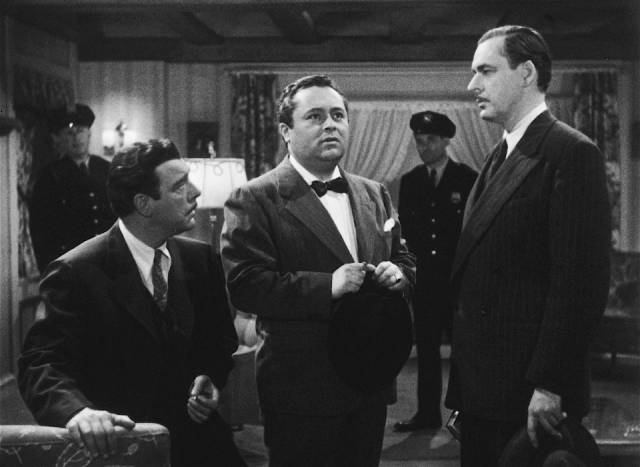 Lawyer Wayne Fletcher (Chaney) distrusts psychic Julian Julian (J. Edward Bromberg) in Wallace Fox's Pillow of Death (1945)