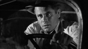 Unemployed engineer Mike Lambert (Glenn Ford) loses his brakes driving down a mountain in Richard Wallace's Framed (1947)