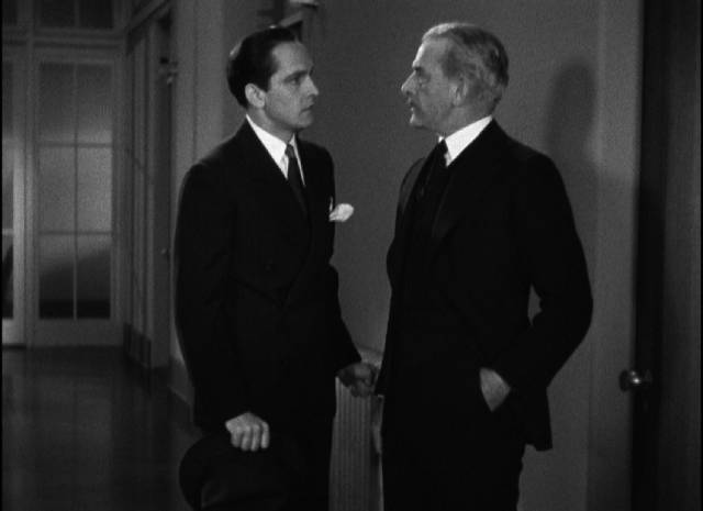 Joan's father (George Irving) tries to turn Jerry (Frederic March) away from her hospital room in Dorothy Arzner's Merrily We Go to Hell (1932)