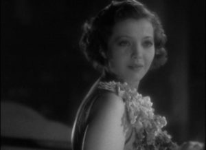Joan (Sylvia Sidney) notices someone on the balcony with her in Dorothy Arzner's Merrily We Go to Hell (1932)