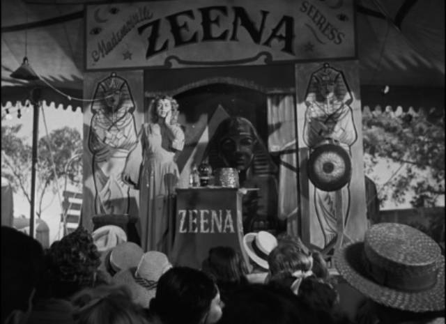 Zeena (Joan Blondell) performs her fake psychic act on the midway in Edmund Goulding's Nightmare Alley (1947)