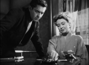 Zeena (Joan Blondell) reads the Tarot and sees something dark ahead for Stan (Tyrone Power) in Edmund Goulding's Nightmare Alley (1947)