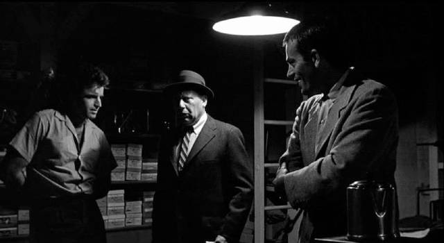 Vince Ryker (Vince Edwards) tries to sell what he thinks is a container of drugs, unaware that it's killing him in Irving Lerner's City of Fear (1959)