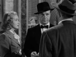 Johnny O'Clock (Dick Powell) is irritated when Inspector Koch (Lee J. Cobb) confronts him in Robert Rossen's Johnny O'Clock (1947)