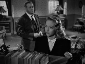 Inspector Koch (Lee J. Cobb) tells Nancy (Evelyn Keyes) that her sister's death was murder in Robert Rossen's Johnny O'Clock (1947)