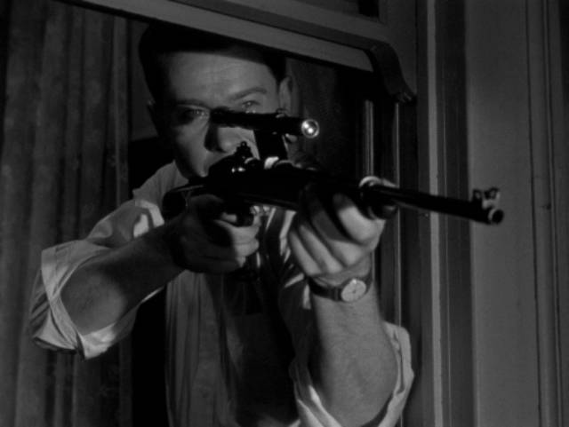 Edward Miller (Arthur Franz) fantasizes about shooting people from his rented room in Edward Dmytryk's The Sniper (1952)