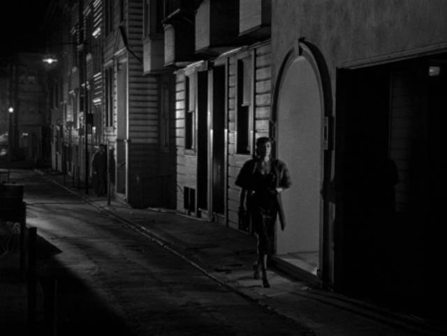 Edward Miller (Arthur Franz) follows Jean Darr (Marie Windsor) to the nightclub where she plays piano in Edward Dmytryk's The Sniper (1952)