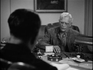 The warden offers Dr. John Garth (Karloff) a chance to continue his research in Nick Grinde's Before I Hang (1940)