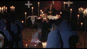 Judge Normad (William Smith) presides of Satanic child sacrifice in John De Hart's Champagne and Bullets (1993)